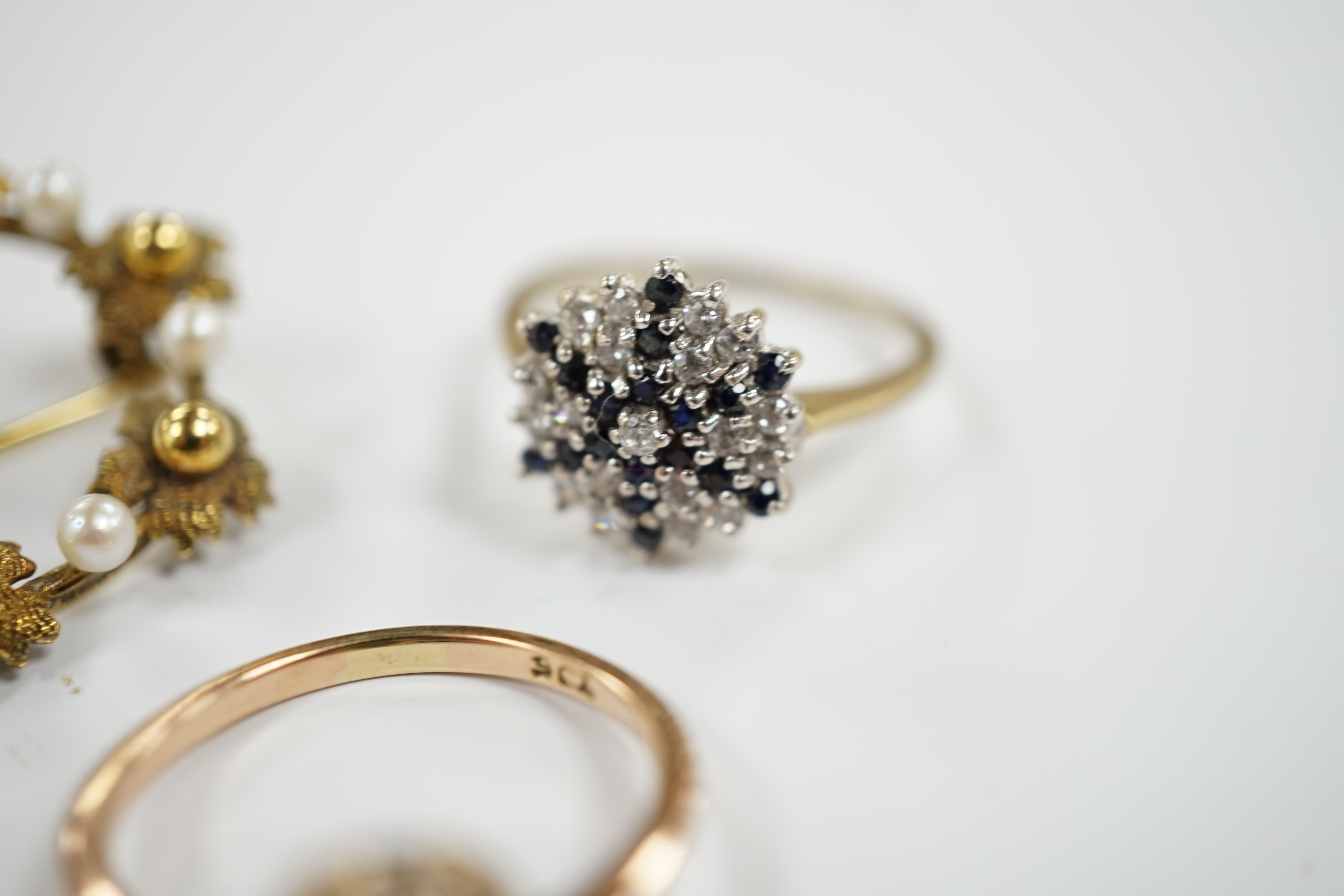 A 9ct gold and two colour sapphire cluster set dress ring, one other 9ct and opal ring and a 9ct gold and cultured pearl set open work circular brooch, gross weight 8.5 grams.